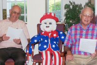 Gene Pfister and Jim Godsey singing with residents